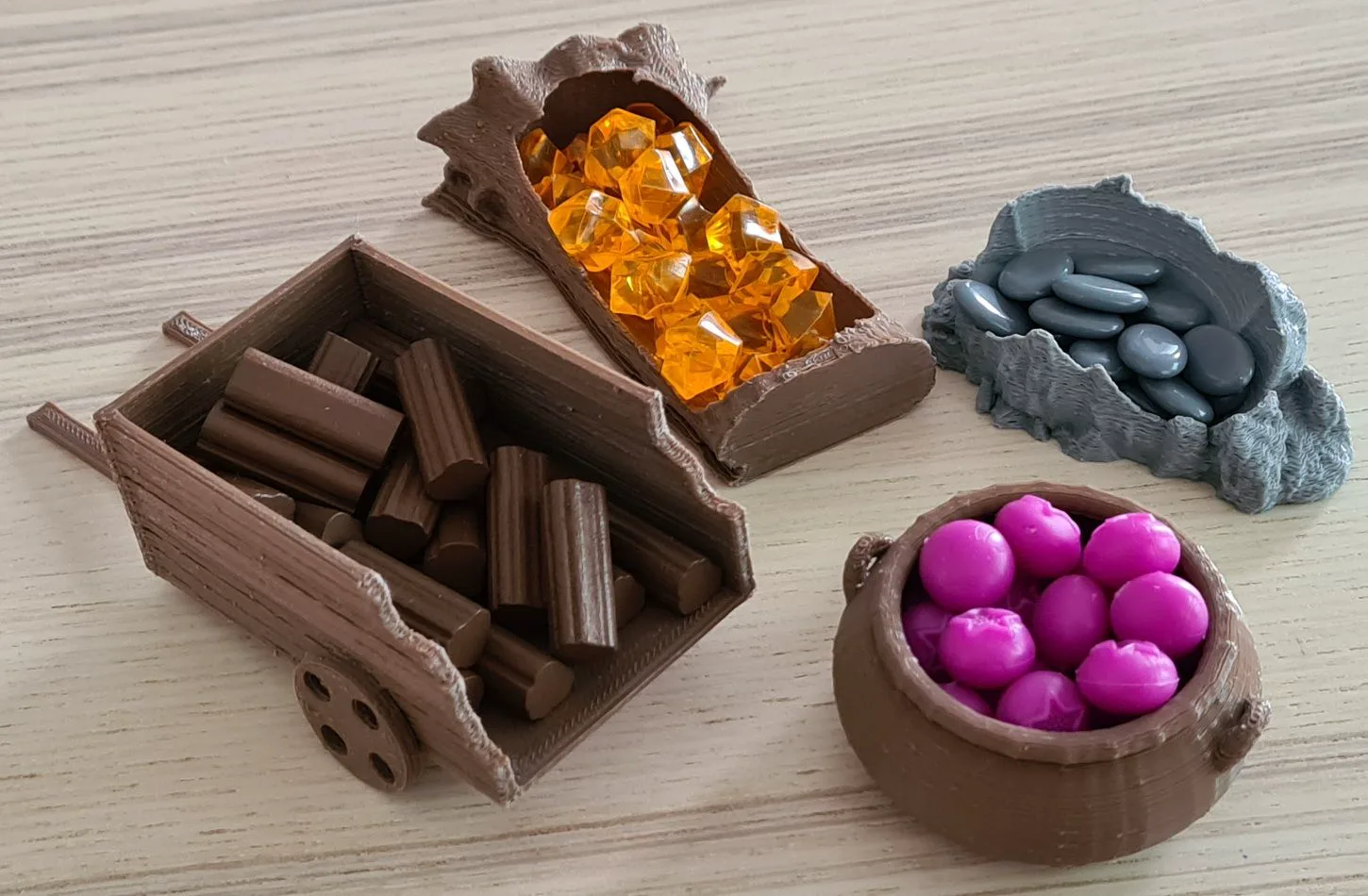 Assorted board game resources held in shaped trays on a tabletop