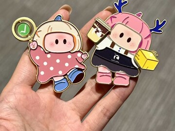 Two colorful character accessories sharing a recognizable face and different outfits