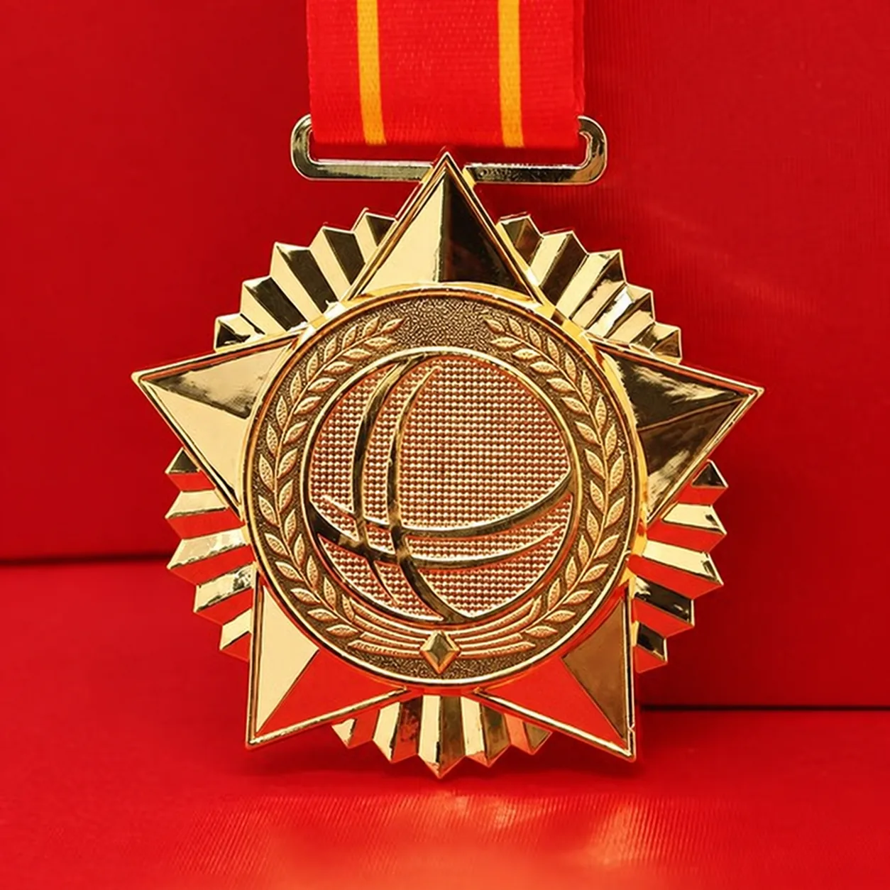 Privacy-edited front view of a gold star-shaped medal