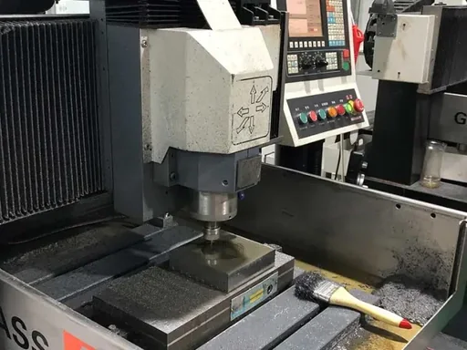 CNC machine cutting a custom metal tooling insert