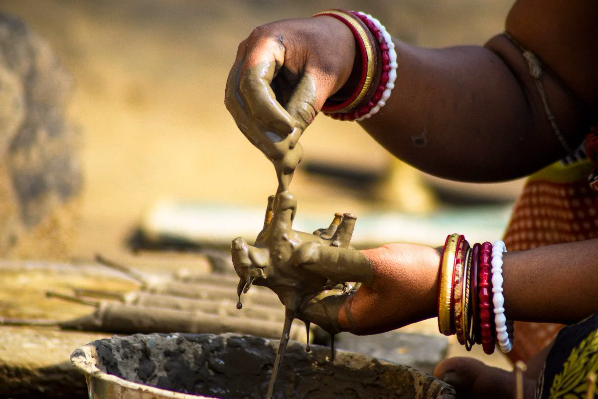 A Dharua artisan in Odisha forming a Dhokra lost-wax cast by hand