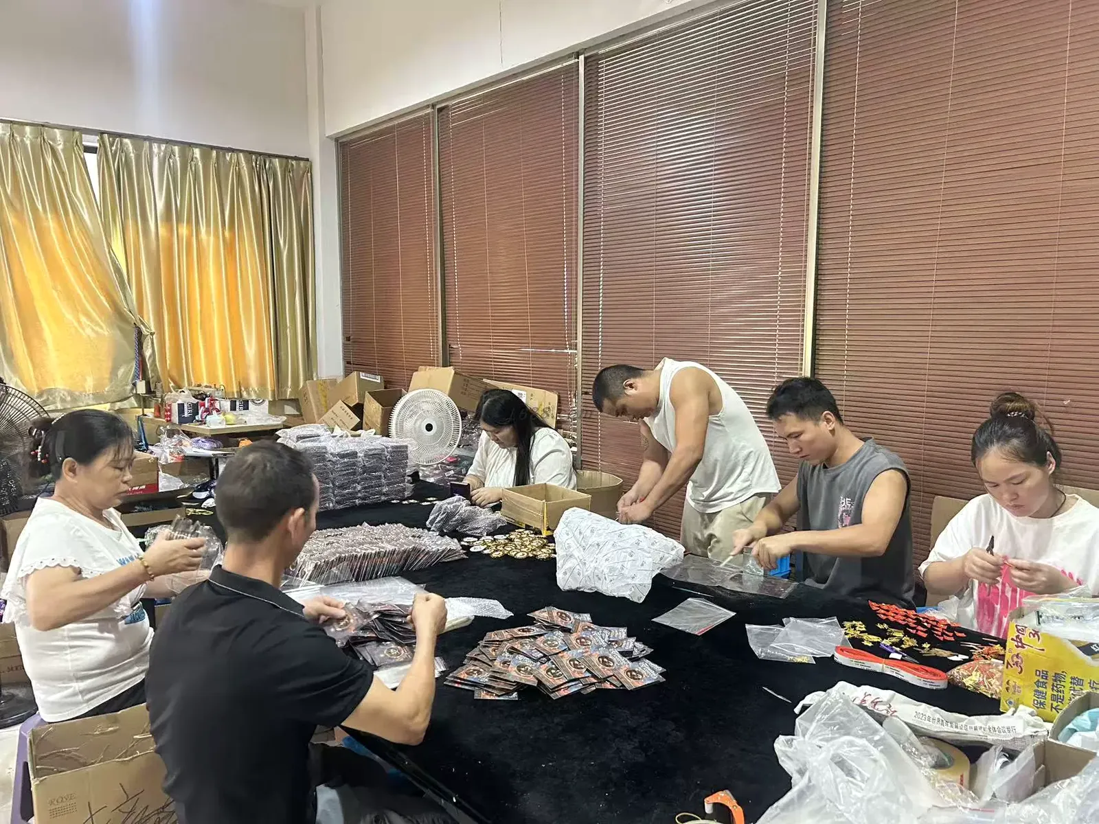 Workers handling quality inspection and packing of custom metal products