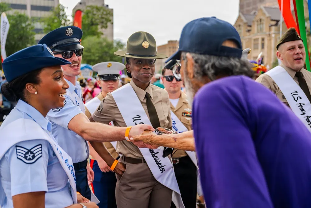 Participants exchanging Fiesta medals during an outdoor San Antonio celebration
