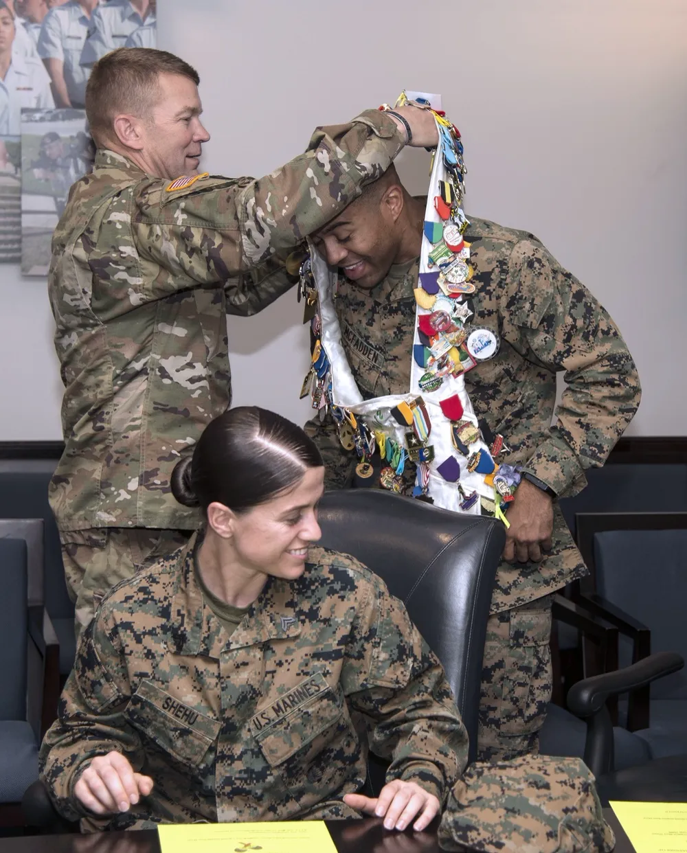 A ceremonial sash covered with many Fiesta medals being placed on a wearer