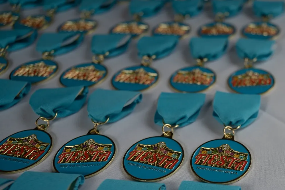 Rows of colorful Fiesta medals attached to short turquoise ribbon drapes