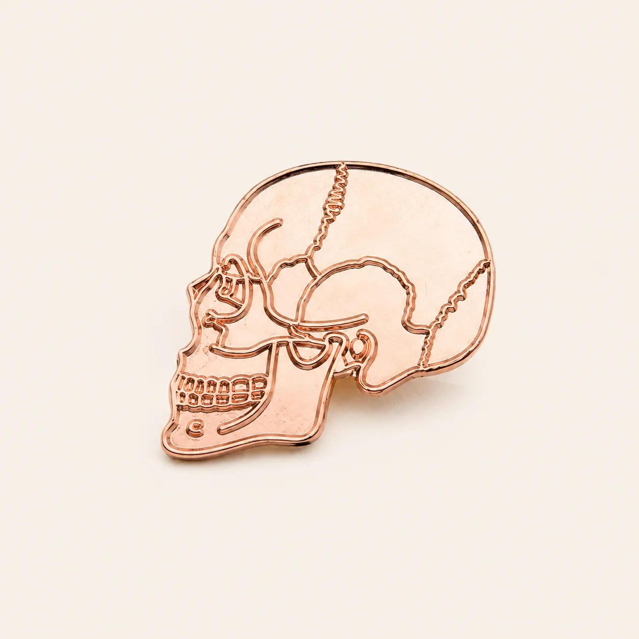 Rose gold or copper-tone plated skull pin