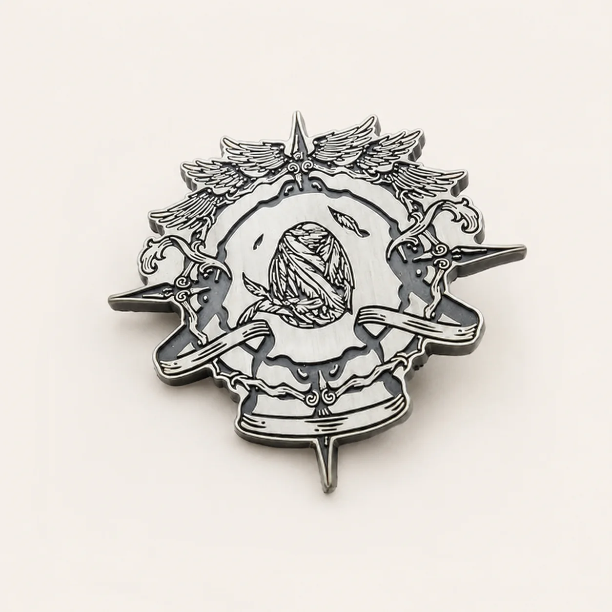 Bright silver or nickel plated metal badge