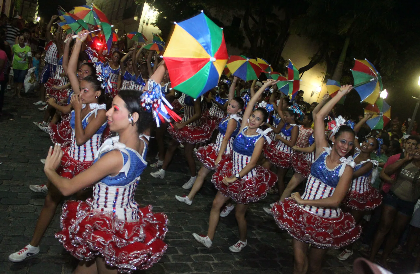Frevo dancers in Olinda, Pernambuco holding small multicolored umbrellas