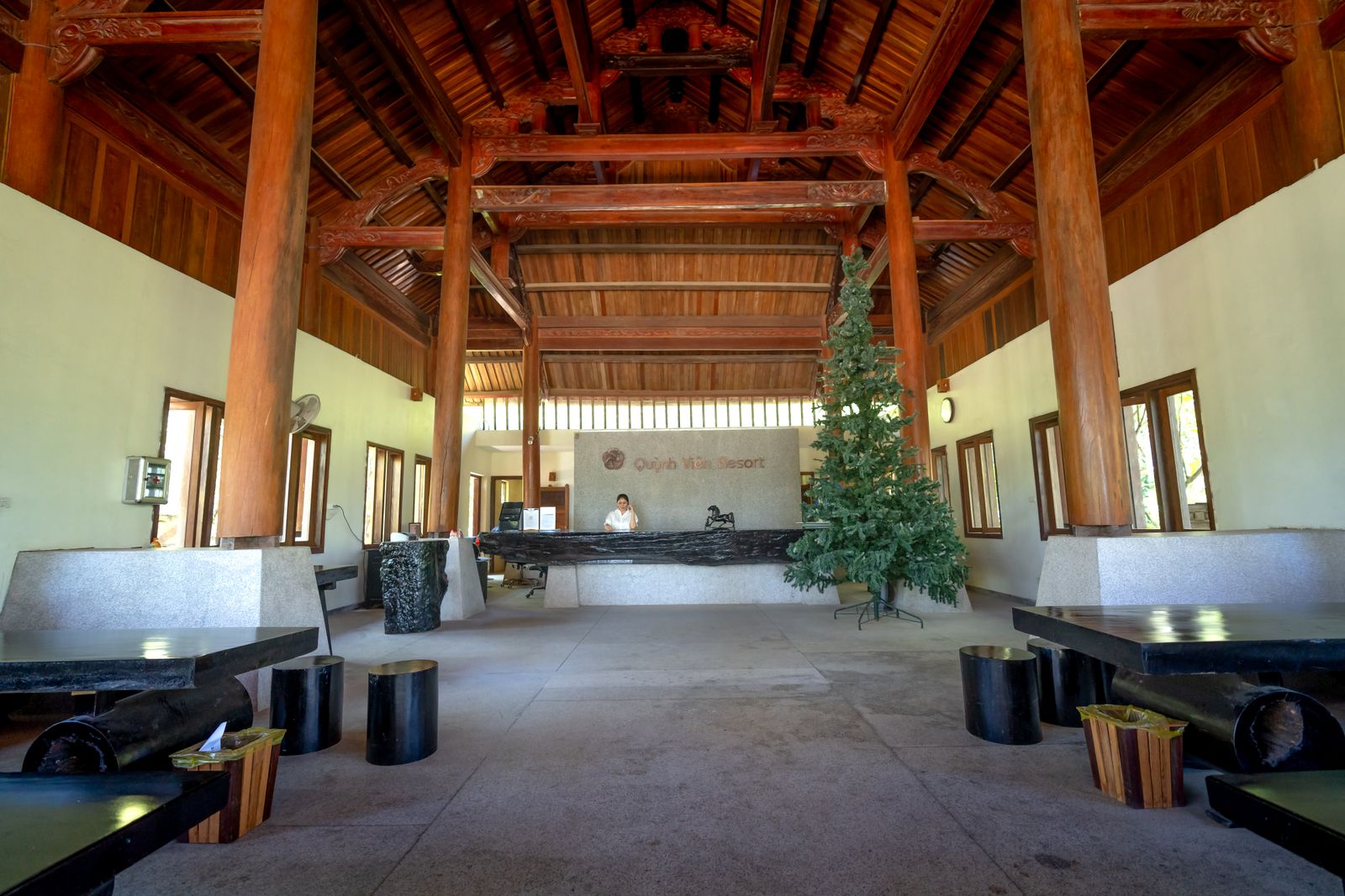 Wooden hotel reception hall with a reception desk and seating
