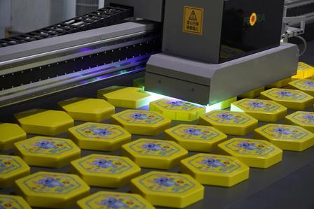 UV printing equipment applying multicolor artwork to custom metal products