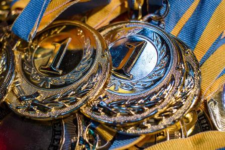 First-place awards with blue and yellow ribbons