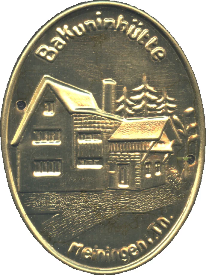 Oval Stocknagel metal badge with two mounting holes